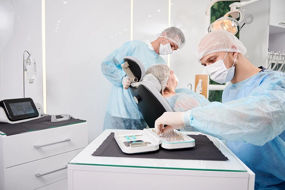 Male-Dentist-Choosing-Dental-Implant