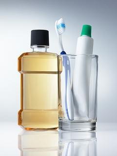 mouthwash and tooth brush in glass image