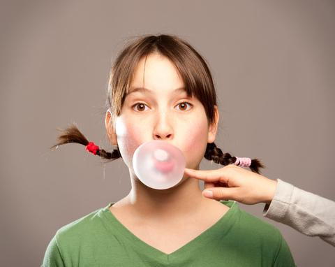 girl blowing bubble image