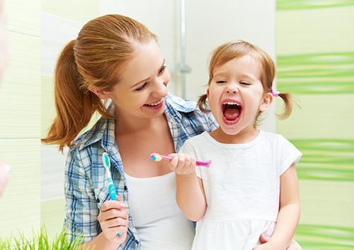 Lady and child with toothbrushes image