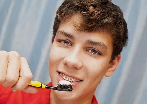 boy brushing teeth image