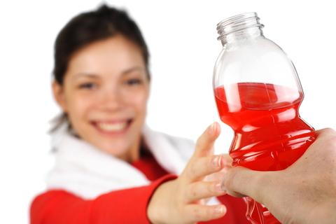 lady receiving a bottled drink image
