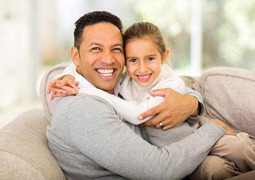 father daughter hugging and smiling image