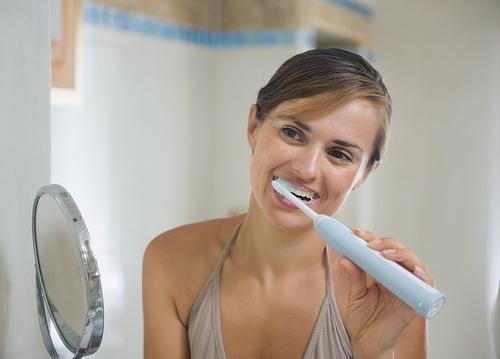 Woman brushing teeth image